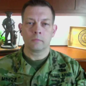 Col. Steven Metze in uniform at his desk in Austin during a 2017 television interview